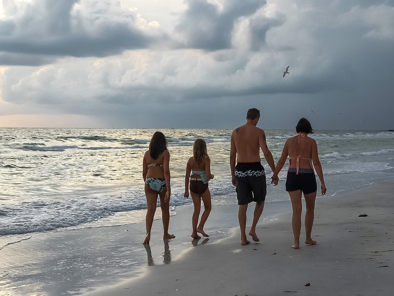 A family walking on the beach during Gulf Shores Labor Day